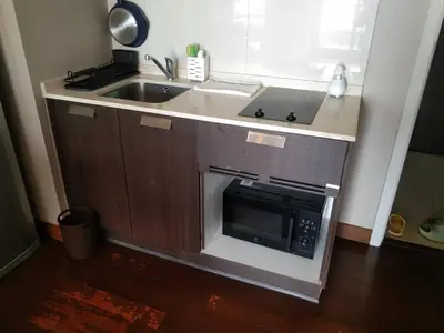 a kitchen with a sink and a microwave at Modern Place Watthana, Thonglor BTS, Sukhumvit in Bangkok