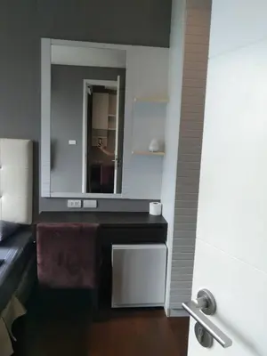 a bathroom with a sink and a mirror at Modern Place Watthana, Thonglor BTS, Sukhumvit in Bangkok