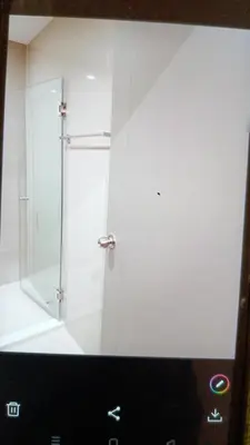 a white bathroom with a shower with a glass door at Cyber carer NSW in Bangkok Yai