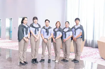 a group of people standing in a room at Queensland Hotel Bangkok in Bangkok