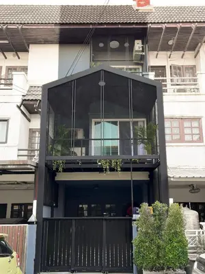 a house with a balcony with plants on it at Enjoyo Getaway in Bangkok