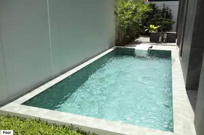 a small swimming pool in the side of a house at Luxury Home Office Srinakarin in Lat Krabang