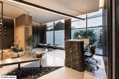 an office with a desk and chairs and windows at Luxury Home Office Srinakarin in Lat Krabang