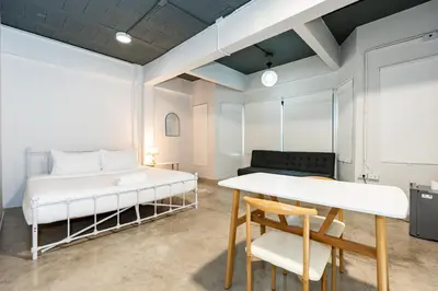 a room with a bed and a table and chairs at xx Yellow Place Sukhumvit 2 - BTS Nana Pro in Bangkok