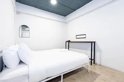 a white bed in a room with a ceiling at xx Yellow Place Sukhumvit 2 - BTS Nana Pro in Bangkok