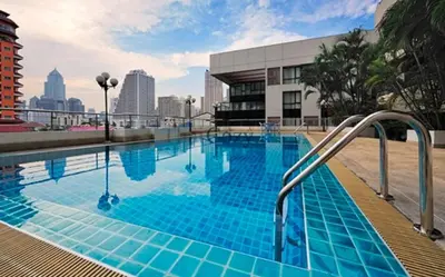 a large swimming pool with blue tiles on a building at Spacious and Renovated 1-Bedroom 100m to Nana BTS - 55 sqm in Bangkok
