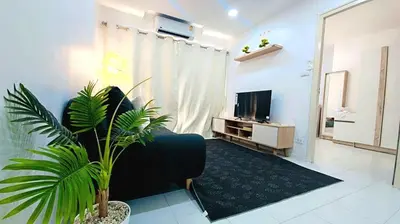 a living room with a couch and a tv at River View 03 in Bangkok