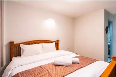 a bedroom with a bed with two towels on it at XX GO INN Khaosan ถนนข้าวสาร in Bangkok