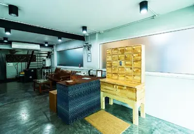 a room with a desk and a table in it at XX GO INN Khaosan ถนนข้าวสาร in Bangkok