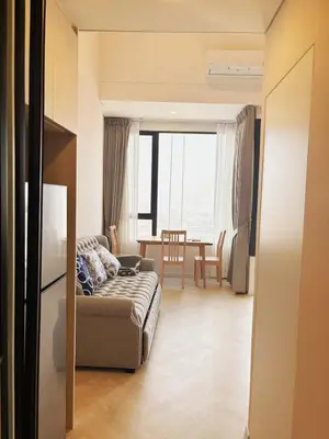 a living room with a couch and a table at Cassia Rama9 Loft Highrise View Central in Bangkok