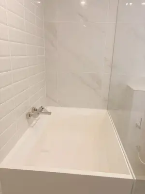 a bathroom with a shower with a white tub at Cassia Rama9 Loft Highrise View Central in Bangkok