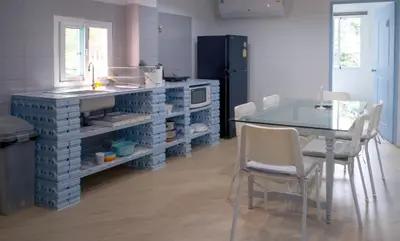 a kitchen with a counter and a table with chairs at Baan Khun Pra No 1 Bangkok Duplex in Bangkok