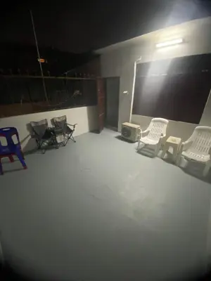 an empty room with chairs and a large screen at Sleep Break Hostel Sathon in Bangkok