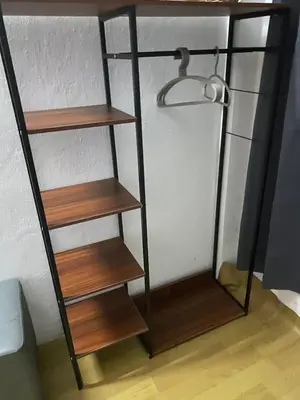 a shelf in a room with wooden shelves at Sleep Break Hostel Sathon in Bangkok