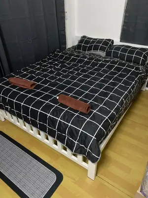 a black and white bed in a room at Sleep Break Hostel Sathon in Bangkok
