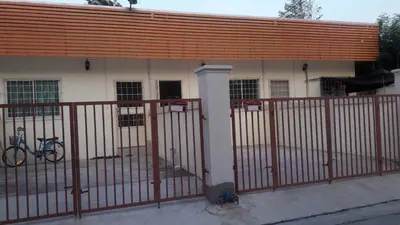 a building with a fence and a bike in front of it at บ้านเช่าดีๆเงียบสงบที่ลงตัว in Ban Lat Tanot