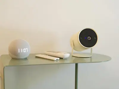 a table with a alarm clock and a phone on it at Siri Designer 3-Storey Townhouse with Garden and Luxury Amenities in Bangkok