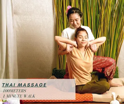 a woman sitting on the floor with a woman cutting her hair at Sukhumvit 81 Haven House- BTS Onnut in Bangkok