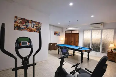 a room with a gym with a pool table at Sukhumvit 81 Haven House- BTS Onnut in Bangkok