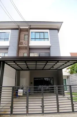 a house with a porch and stairs in front of it at Cozy Homey Place Townhome in Bangkok