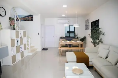 a living room with a couch and a table at Cozy Homey Place Townhome in Bangkok