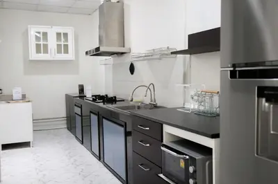 a kitchen with a sink and a counter top at Cozy Homey Place Townhome in Bangkok