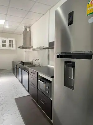 a kitchen with a sink and a stove at Cozy Homey Place Townhome in Bangkok