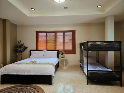 a bedroom with a bed and a bunk bed at Relax Inn DMK in Lak Si