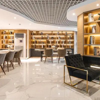 a lobby with chairs and a table and shelves at Beautiful Studio Room Near MRT in Bangkok