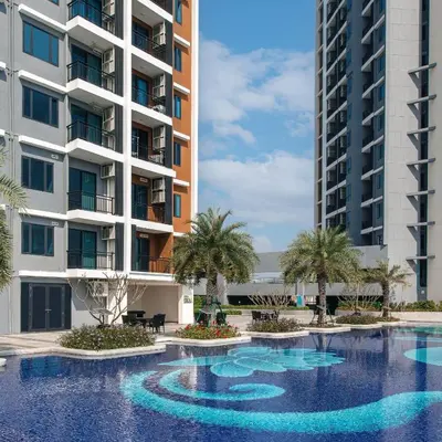 a swimming pool in front of two tall buildings at Beautiful Studio Room Near MRT in Bangkok