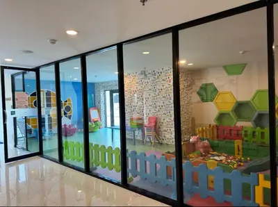 a room with sliding glass doors with a play room at Beautiful Studio Room Near MRT in Bangkok