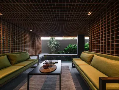a living room with two couches and a table at Norma Hotel Sathorn in Bangkok