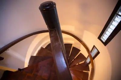 a spiral staircase in a house with a window at Home16 Sukhumvit16 in Bangkok