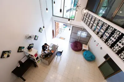 an overhead view of a room with a man sitting at a desk at Home16 Sukhumvit16 in Bangkok