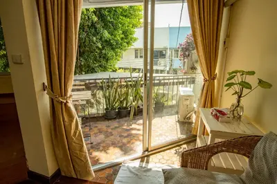 a room with a sliding glass door to a patio at Home16 Sukhumvit16 in Bangkok