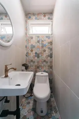 a bathroom with a white toilet and a sink at Home 18 - Cozy Hideout in Bangkok in Bangkok