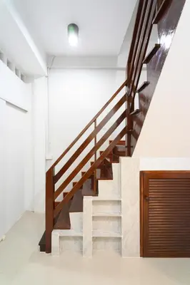 a staircase in a house with wooden railings at Home 18 - Cozy Hideout in Bangkok in Bangkok
