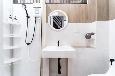 a bathroom with a sink and a shower with a mirror at Home 18 - Cozy Hideout in Bangkok in Bangkok