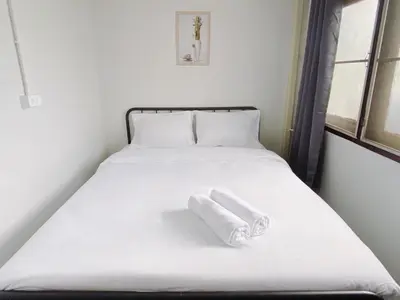 a white bed with two towels on it at xx BAO The Giant Swing - Sao Chingcha - เบา ศาลเจ้าพ่อเสือ เสาชิงช้า in Bangkok