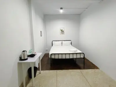 a white room with a bed and a table at xx BAO The Giant Swing - Sao Chingcha - เบา ศาลเจ้าพ่อเสือ เสาชิงช้า in Bangkok