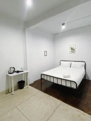 a white bedroom with a bed and a table at xx BAO The Giant Swing - Sao Chingcha - เบา ศาลเจ้าพ่อเสือ เสาชิงช้า in Bangkok