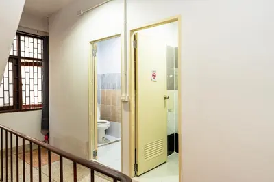 a bathroom with a door to a toilet at xx BAO The Giant Swing - Sao Chingcha - เบา ศาลเจ้าพ่อเสือ เสาชิงช้า in Bangkok