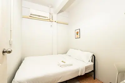 a small bedroom with a bed with white sheets at xx BAO The Giant Swing - Sao Chingcha - เบา ศาลเจ้าพ่อเสือ เสาชิงช้า in Bangkok
