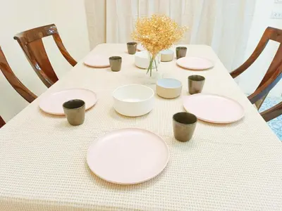a table with white plates and cups on it at Retreat House 81 - BTS Onnut in Bangkok
