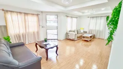 a living room with a couch and a table at Retreat House 81 - BTS Onnut in Bangkok