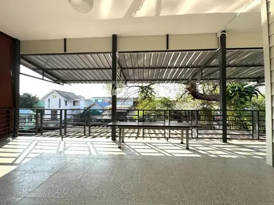 a pavilion with a table and a tree on a balcony at DD Canel in Bangkok