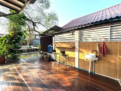 a deck with chairs and a bar on a house at DD Canel in Bangkok