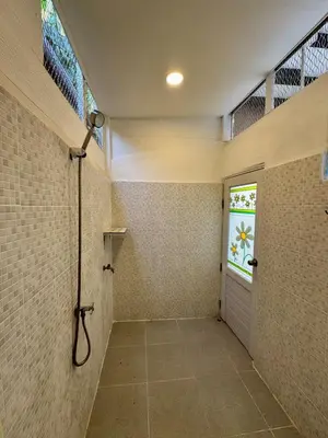 a bathroom with a shower with a door and a window at DD Canel in Bangkok