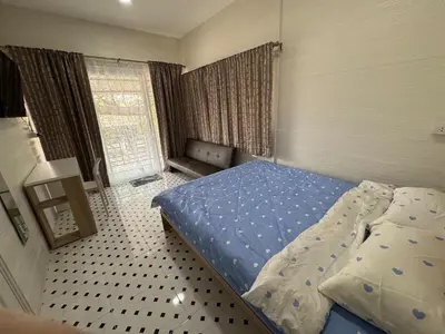 a bedroom with a bed in a room with a window at DD Canel in Bangkok