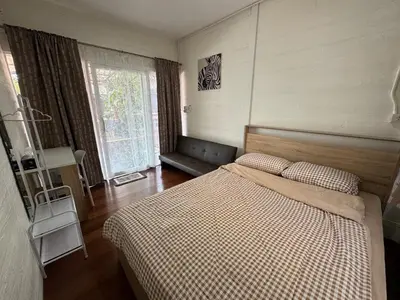 a bedroom with a bed with a checkered blanket at DD Canel in Bangkok